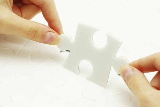 hands holding a puzzle piece . business concepts