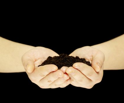earth is in hands isolated on black