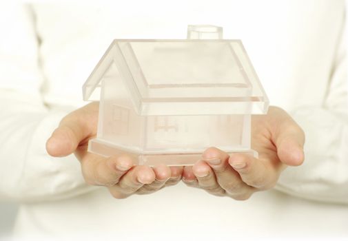 The house in human hands on white