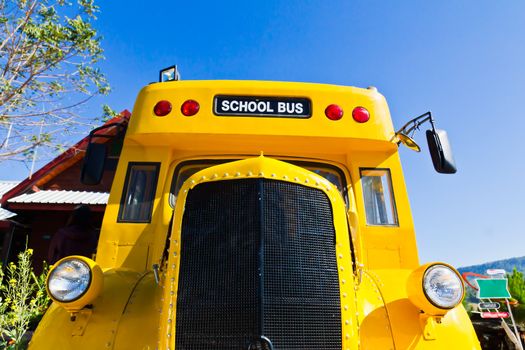 Yellow school bus against blue sky