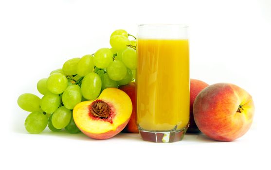 Glass with freshly made peach juice on a white background