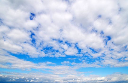 Blue sky background with tiny clouds