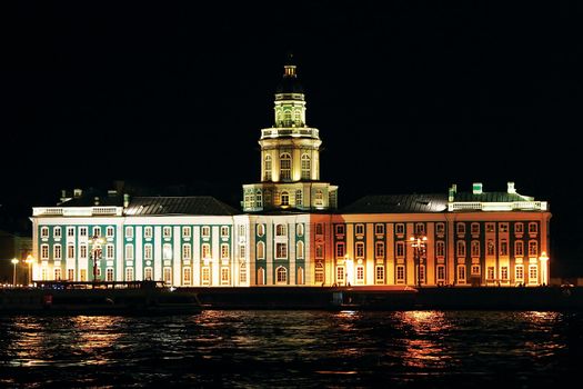 Night photo of Kunstkamery illuminated a building in the city of S-peterburge.