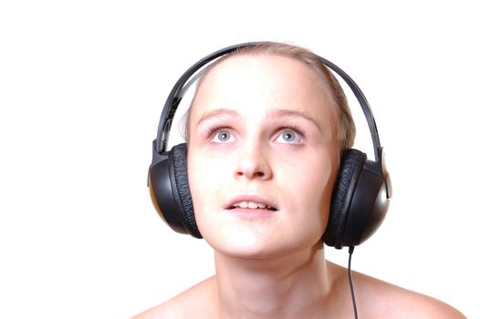 Portrait of a girl with headphones, standing against isolated white background 