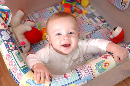 Smiling child playing in the cot, family scenes