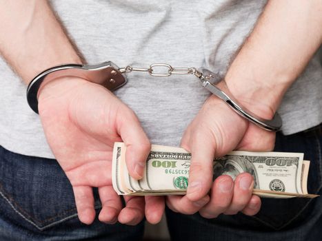 Handcuffs arrests dollar currency crime human hand