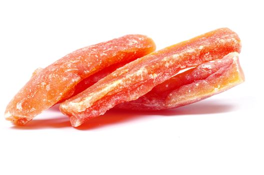 orange dried papaya slices over white background