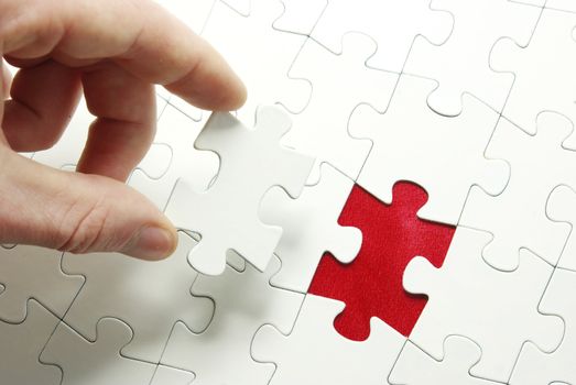 hands holding a puzzle piece . business concepts