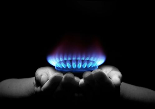 Hands holding a flame gas
