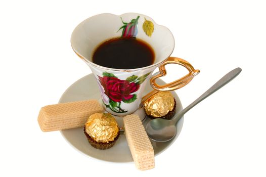 Old china cup of tea (or coffee) and sweeties on isolated background.