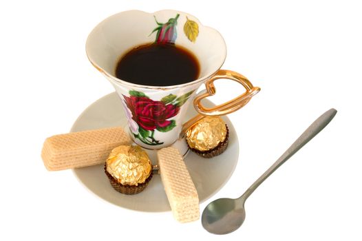 Old china cup of tea (or coffee) and sweeties on isolated background.