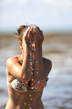 Woman refreshing on the beach