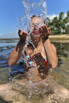 Woman refreshing on the beach