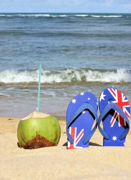 Thongs and coconut on the beach in Brazil.