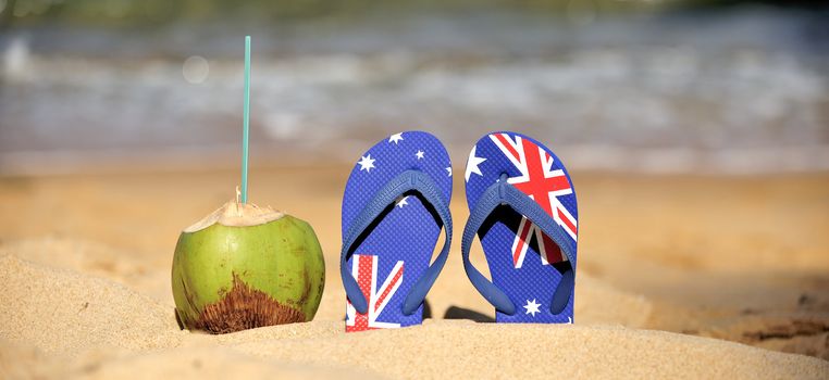 Thongs and coconut on the beach in Brazil.