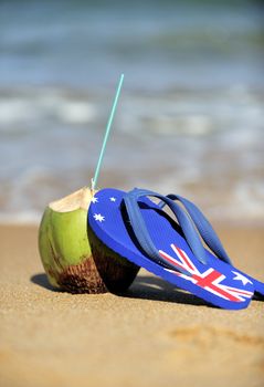 Thongs and coconut on the beach in Brazil.