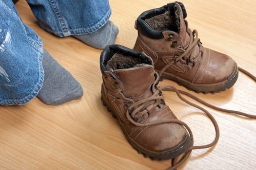 Little child boy tying foot sport shoe lace