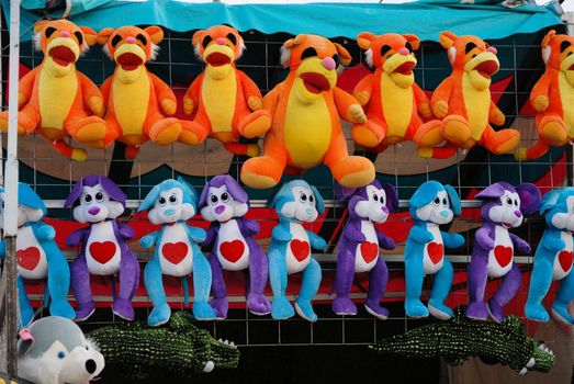 Stuffed animals at the fair, ready to be won.