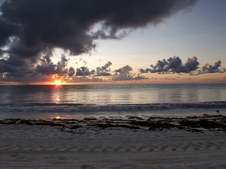 Sunrise at a beach on a cloudy day