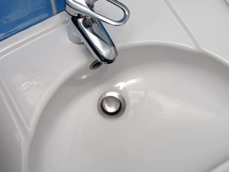 Clean sink and faucet at home toilet or bathroom