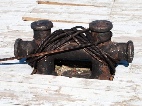 Sea sailing vessel rope moored to nautical bollard