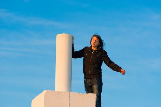 Teenager having reached the top and enjoying the moment, a concept