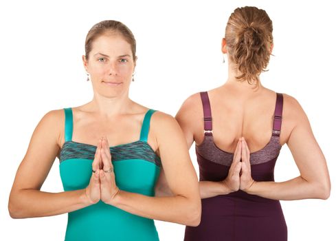 Two Caucasian yoga women in Namaskar posture