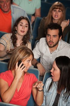 Woman on phone annoys audience in theater