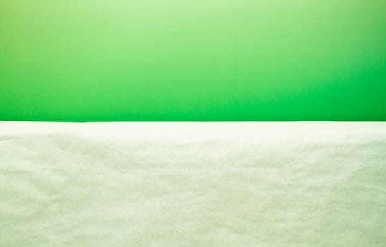 a white paper in front of green paper background serve as a simple background