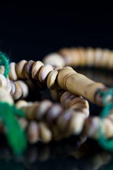 wooden rosary close up with green string