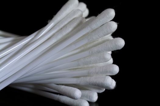 close up view of cotton wool buds on black background