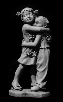 Emotional stone statue showing a big sister protecting her little brother.