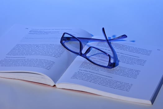 photo of eyeglasses lie on the book