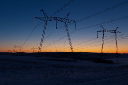 Cold winter daybreak above high voltage powerlines