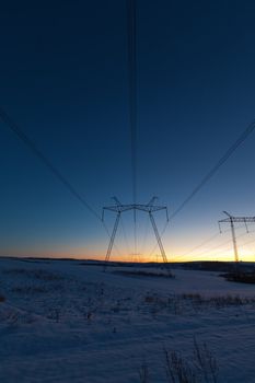 Cold winter daybreak above high voltage powerlines