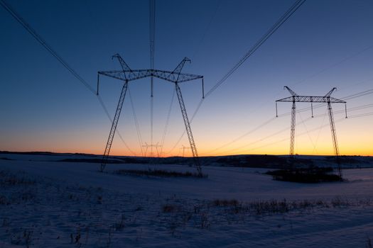 Cold winter daybreak above high voltage powerlines