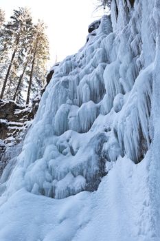 Image of a frozen waterfall in deep rock canyon in Carpathian mountains near Manyava village