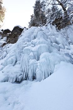 Image of a frozen waterfall in deep rock canyon in Carpathian mountains near Manyava village
