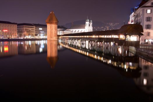 Landscape of Lake Lucern and Famous wooden Chapel bridge foot walkway Switzerland at Night
