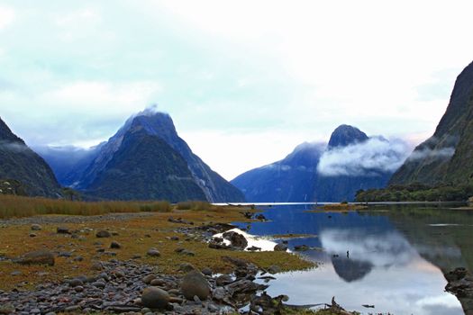reflection of high mountain glacier at milford sound fiordland of New Zealand