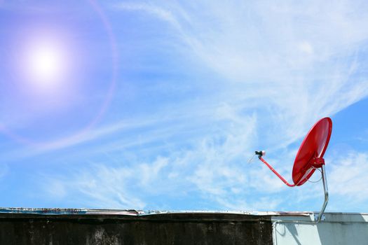 isolated red satellite on sunny blue sky