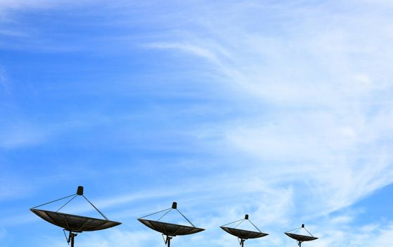 black antenna communication satellite dish over blue sky