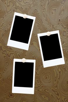 blank polaroids frames on a wood background