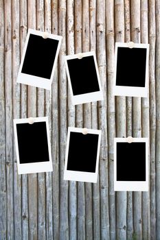 six blank polaroids frames on a bamboo background