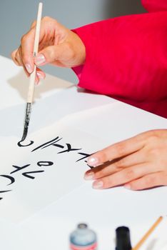 Korean girl write the word on paper close up