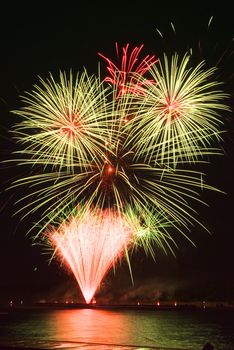 Many golden fireworks bursts at fireworks festival.