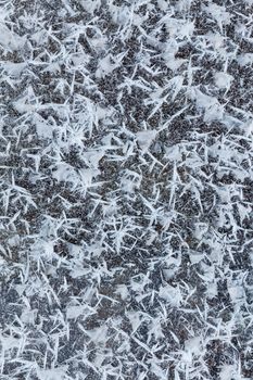 Beautiful closeup of big icy snowflakes on frozen lake