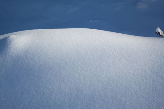 Image of snowbound field divided by shadow and light zones