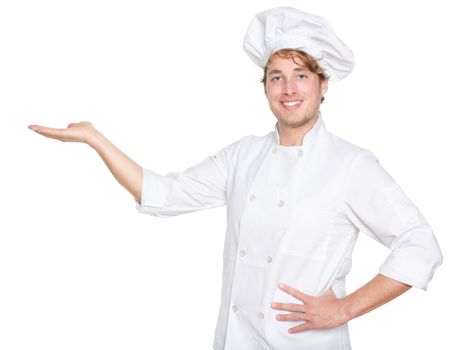 Chef, Cook or baker showing isolated. Male chef presenting your product. Young Caucasian man isolated on white background in chefs uniform.