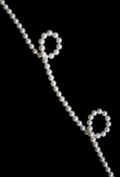 White pearls on the black velvet  background
